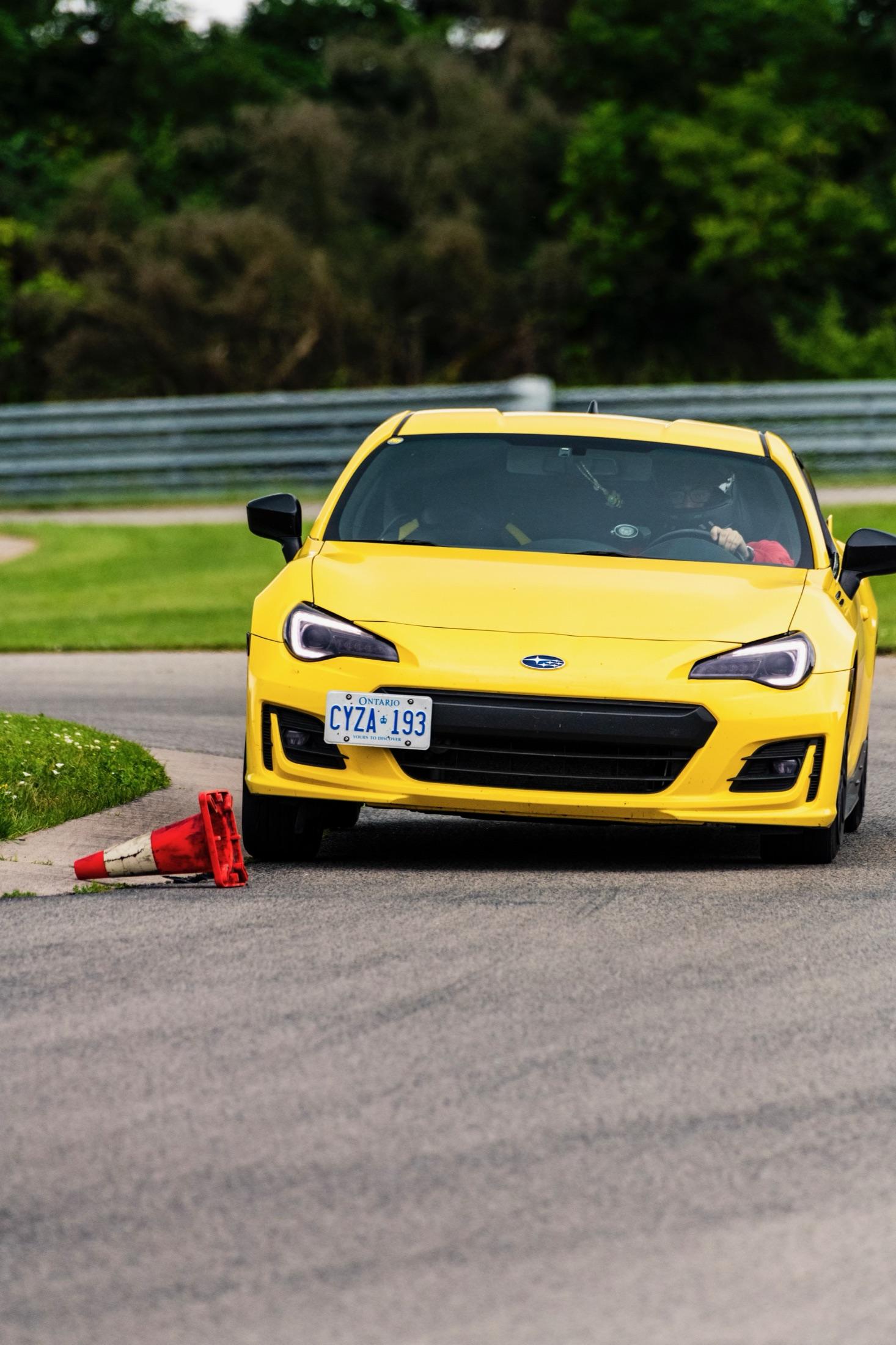 Yellow Subaru BRZ cornering on track